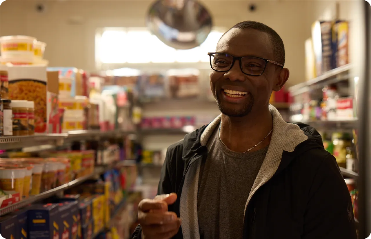 A smiling person in a grocery store